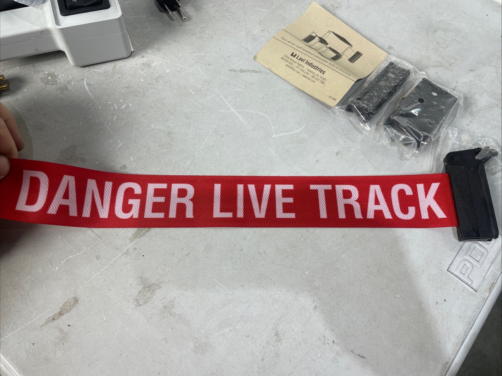 lavi industries 7-13 ft retractable belt wall mount danger live track